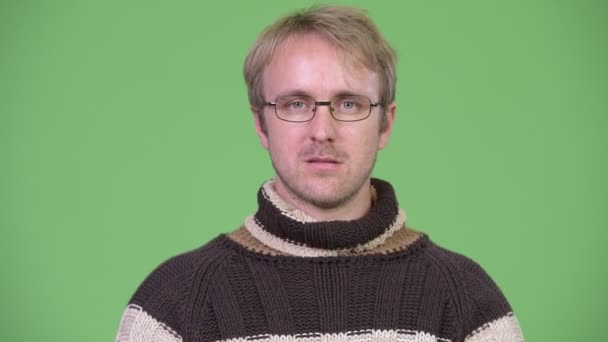 Studio shot of blonde handsome man covering eyes as three wise monkeys concept — Stock Video