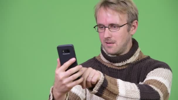 Studio shot of stressed man using phone and getting bad news — Stock Video