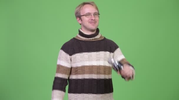 Studio shot of happy handsome man as host with microphone — Stock Video