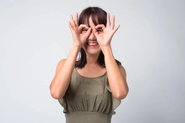 Portrait of beautiful Asian woman against white background — Stock Photo, Image