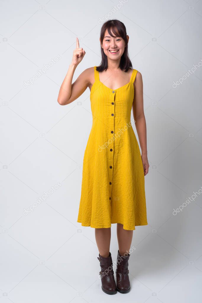Portrait of beautiful Asian woman wearing yellow dress
