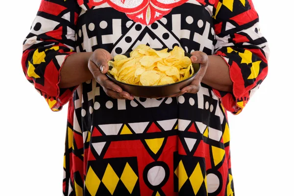 Studio shot of fat black African woman holding bowl of potato ch — Stock Photo, Image