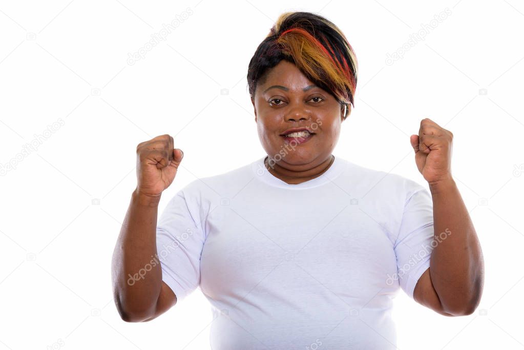 Studio shot of happy fat black African woman smiling while looki