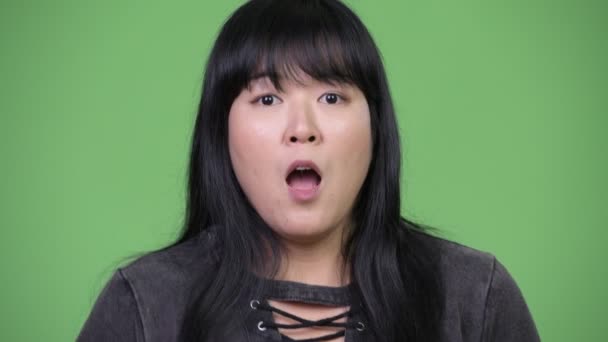 Beautiful overweight Asian woman looking shocked — Stock Video