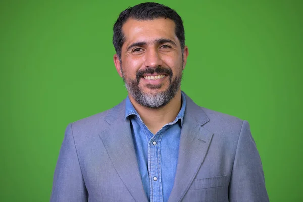 Schöner persischer bärtiger Geschäftsmann mit grünem Hintergrund — Stockfoto
