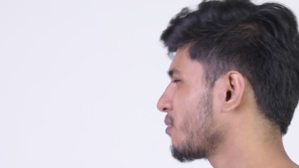 Profile view of young angry bearded Indian man complaining — Stock Video