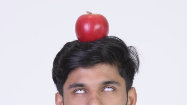 Young Indian man with apple on head — Stock Video