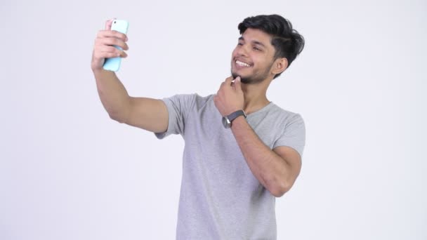 Young happy bearded Indian man taking selfie — Stock Video