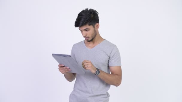 Jovem homem indiano barbudo feliz usando tablet digital e olhando surpreso — Vídeo de Stock