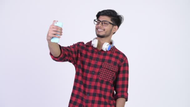 Young happy bearded Indian hipster man taking selfie — Stock Video