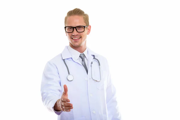 Studio colpo di giovane felice uomo medico sorridente mentre dà le mani — Foto Stock