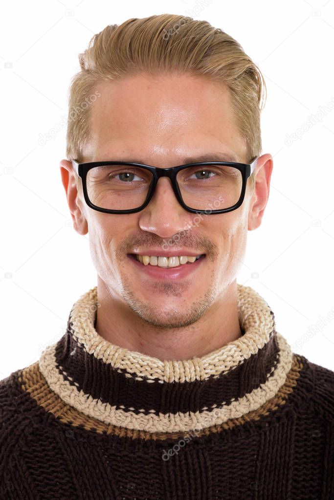 Face of happy young handsome man smiling while wearing eyeglasse