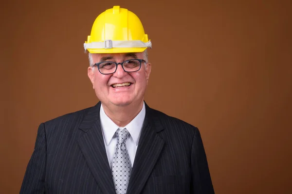 Portrait of overweight senior businessman with hardhat — Stock Photo, Image