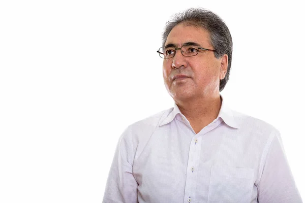 Studio shot of senior Persian man thinking while looking up — Stock Photo, Image