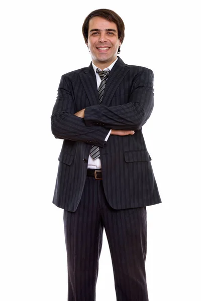 Studio shot of young happy Persian businessman smiling and stand — Stock Photo, Image