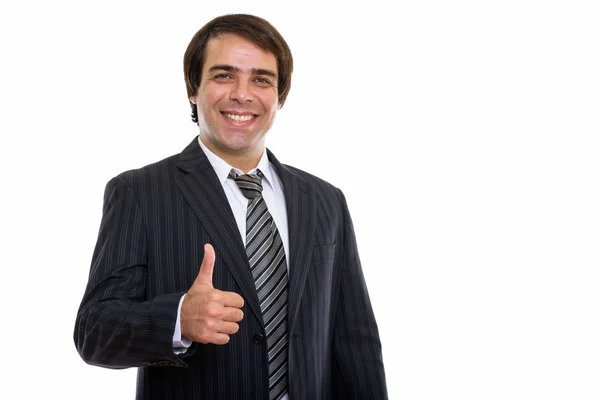 Studio shot of young happy Persian businessman smiling while giv — Stock Photo, Image