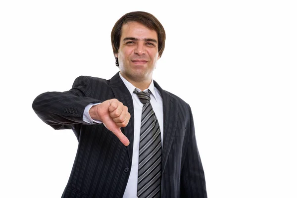 Studio shot of young Persian businessman giving thumb down — Stock Photo, Image