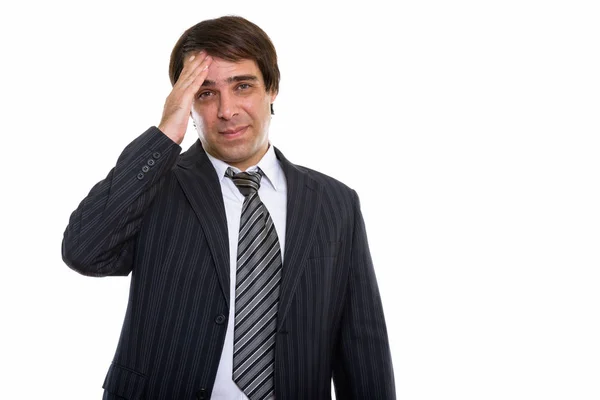 Studio shot of young Persian businessman looking stressed — Stock Photo, Image