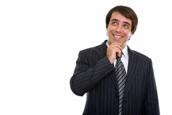 Studio shot of young happy Persian businessman smiling while thi — Stock Photo, Image