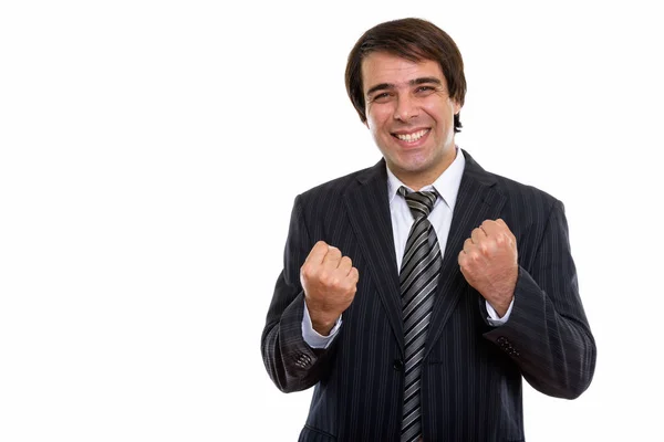 Studio shot of young happy Persian businessman smiling while loo — Stock Photo, Image