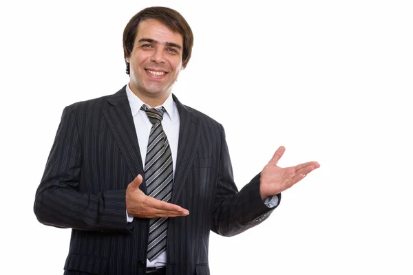 Studio shot of young happy Persian businessman smiling while sho — Stock Photo, Image