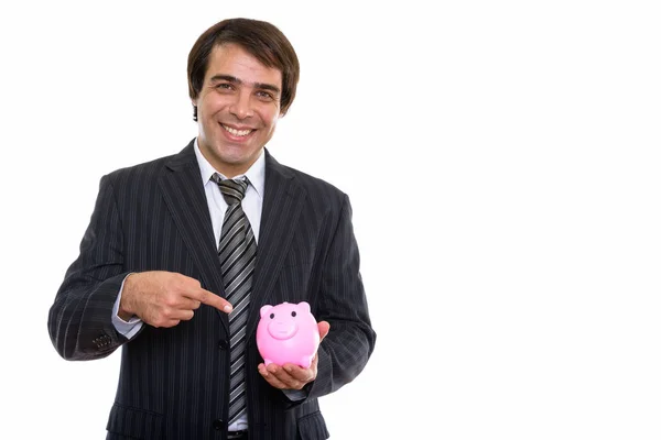 Studio shot of young happy Persian businessman smiling while hol — Stock Photo, Image