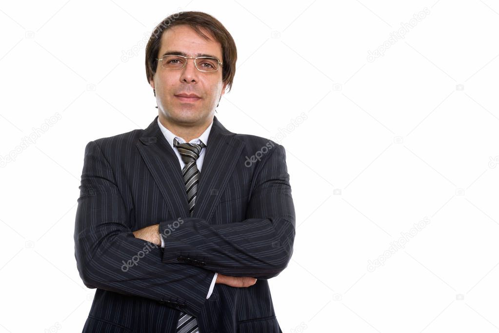 Studio shot of young Persian businessman wearing eyeglasses with