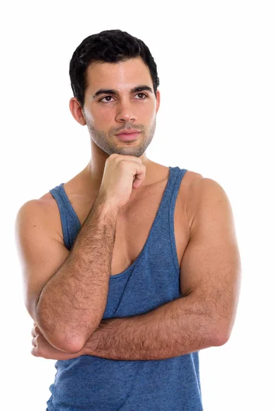 Estudio toma de joven guapo hispano hombre pensando mientras lookin —  Fotos de Stock