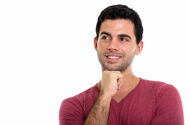 Estudio toma de joven feliz hispano hombre sonriendo y pensando whi —  Fotos de Stock