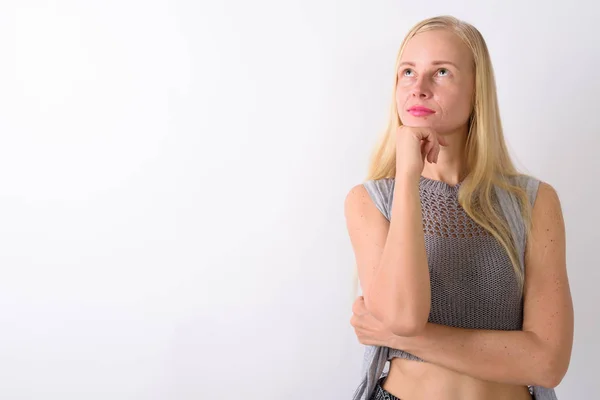 Beautiful blond woman standing against white background — Stock Photo, Image