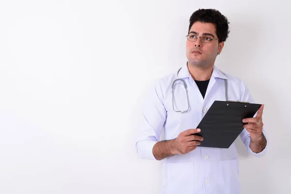 Young handsome Persian man doctor wearing eyeglasses against whi — Stock Photo, Image