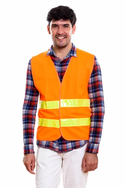 Studio shot of young happy Persian man construction worker smili — Stock Photo, Image