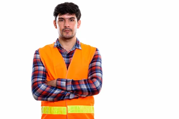 Studio shot of young Persian man construction worker with arms c — Stock Photo, Image
