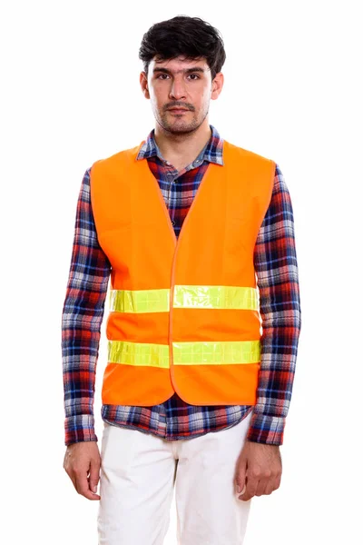 Studio shot of young Persian man construction worker standing — Stock Photo, Image