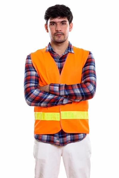 Studio shot of young Persian man construction worker standing wi — Stock Photo, Image