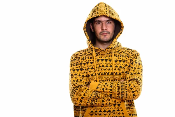 Studio shot of young Persian man wearing hoodie with arms crosse — Stock Photo, Image