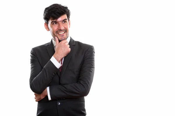 Studio shot van jonge gelukkig Perzisch zakenman glimlachen terwijl thi — Stockfoto