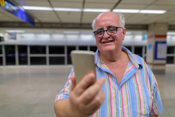 Overweight senior tourist man exploring around the city of Bangk