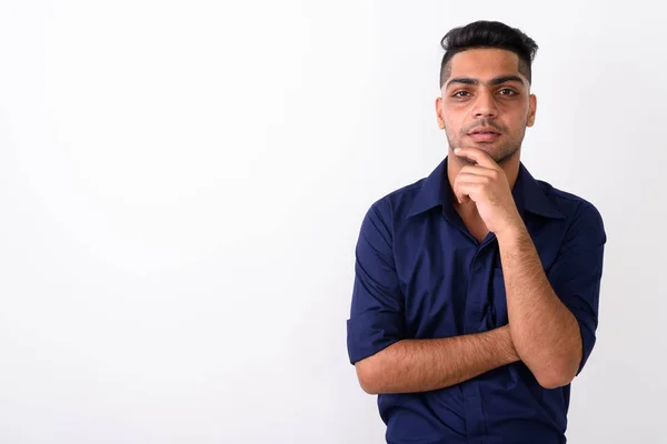 Studio shot of young Indian businessman against white background — Stock Photo, Image