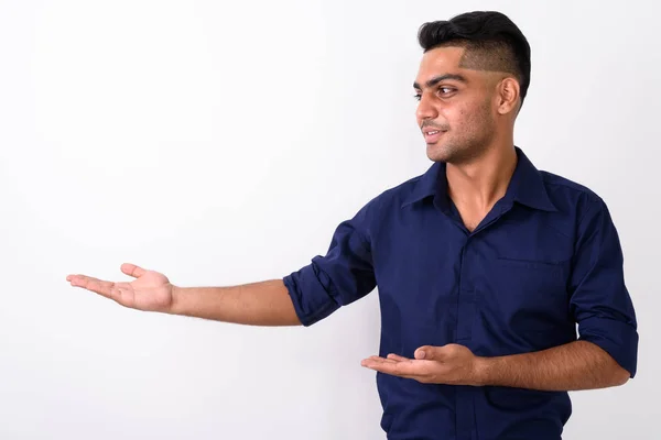 Studio shot of young Indian businessman against white background — Stock Photo, Image