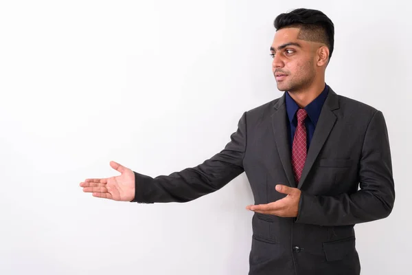 Young Indian businessman wearing suit against white background — Stock Photo, Image