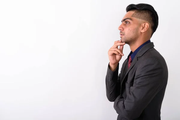 Young Indian businessman wearing suit against white background — Stock Photo, Image