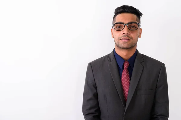 Young Indian businessman wearing suit against white background — Stock Photo, Image