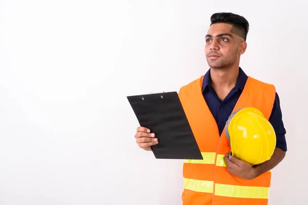 Young Indian man construction worker against white background
