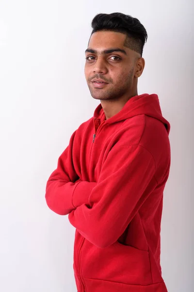 Young Indian man wearing hoodie against white background — Stock Photo, Image