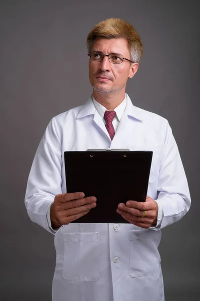 灰色の背景のブロンドの髪を持つ男医師 — ストック写真