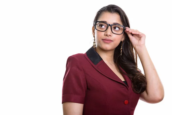 Young beautiful Indian businesswoman thinking while looking up a Stock Image