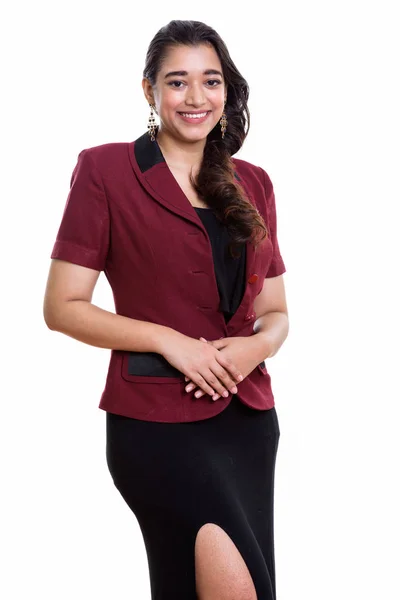 Studio shot of young happy Indian businesswoman smiling while st — Stock Photo, Image