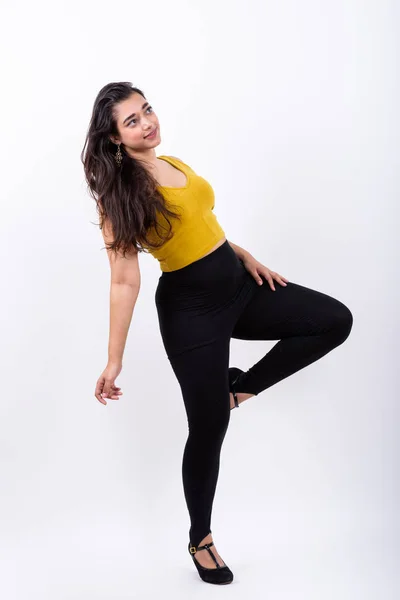 Full body shot of young beautiful Indian woman posing while thin