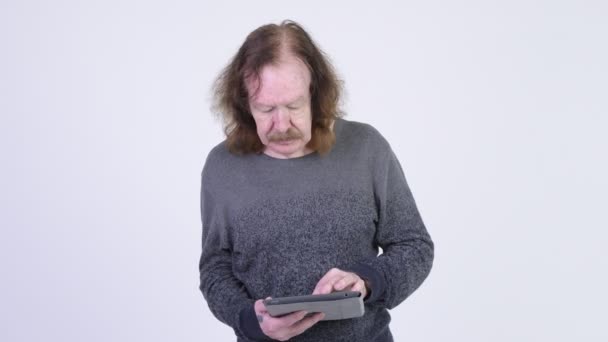 Happy senior man with mustache using digital tablet — Stock Video